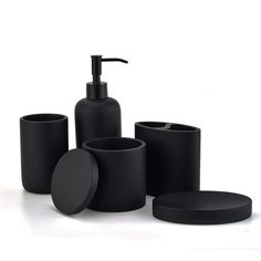 black bathroom accessories including soap dispenser, toothbrush holder, and cup