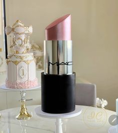 three different colored lipsticks on top of each other in front of a mirror and table