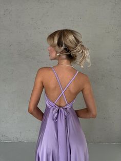 the back of a woman wearing a purple dress