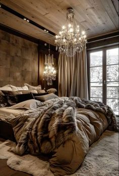 a bedroom with a large bed and chandelier hanging from the ceiling