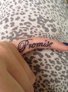 someone has their finger tattooed with the word prome