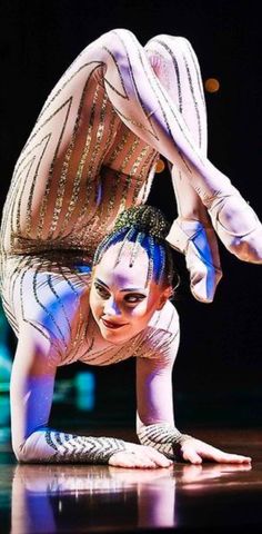 a woman is doing a handstand on the floor