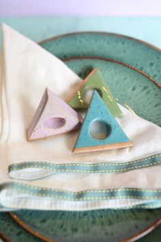 a plate topped with different types of decorative items next to a napkin on top of a table