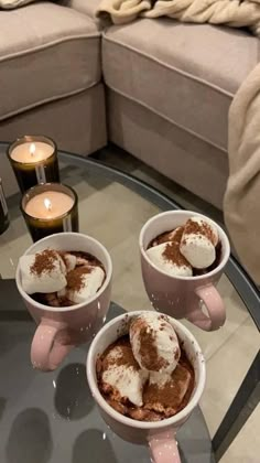 three cups of hot chocolate on a glass table