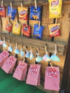 the back yard movie party is set up with popcorn bags and candy bars on clothes pins