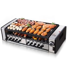 an electric grill with different types of meats and vegetables on it's side