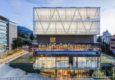 an aerial view of the building's glass facade and its surrounding courtyard, with stairs leading up to it