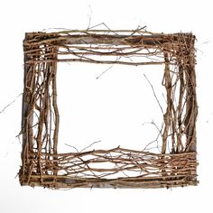 a square frame made out of branches on a white background