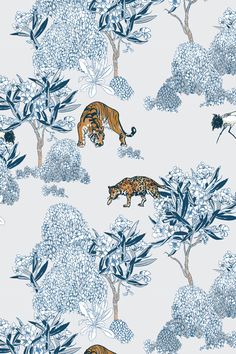 two tigers are running through the trees in this blue and white wallpaper pattern,