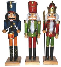 three wooden nutcrackers standing next to each other