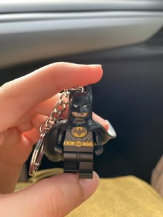 a hand holding a lego batman key chain