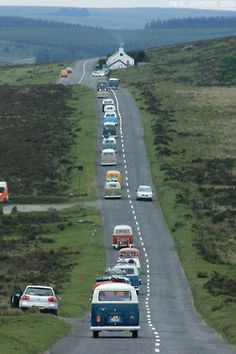 several cars are driving down the road in traffic