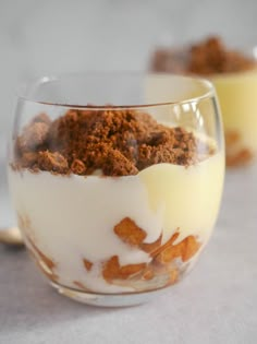 two glasses filled with dessert sitting next to each other