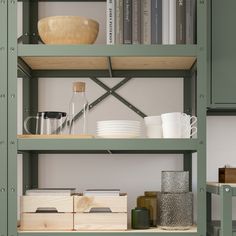 the shelves in this kitchen are filled with dishes, cups and other things on them