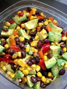 a salad with avocado, black beans and corn