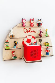 a wooden shelf filled with toys and figurines