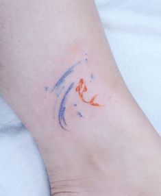 a small tattoo on the foot of a person with a fish in it's body