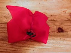 a red bow on top of a wooden table