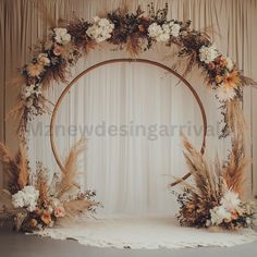 a wedding arch decorated with flowers and feathers