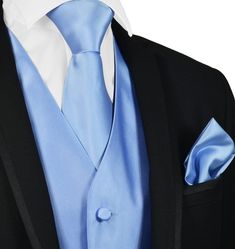 a man in a suit with a blue tie and pocket square on his lapel