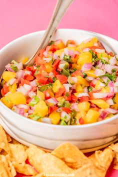 a white bowl filled with salsa next to tortilla chips