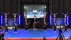 a group of cheerleaders standing on top of a stage