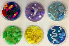 four plastic trays filled with different types of buttons and bead spools