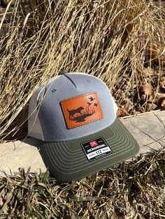 These leather patch Richardson 112FP hats are a great way to flaunt your style and look sleek at the same time. Patches made from 100% leather and engraved with a crisp design and hand stitched on our most popular style of hat. Your friends are going to be jealous! To submit custom logo- Please email brent@lumberjackdesignco.com with the Vector logo, it will be labeled .eps, .ai, .pdf (Please do not submit a jpg in this format as this will need redrawn and art charges will apply for hourly rates!) Multiple hat colors available, Bulk pricing available (see below) custom shape patches available upon request. SIZE OF PATCH HEIGHT WILL VARY DEPENDING ON CUSTOMER LOGO If a hat color is not listed please message us and we can order in a custom color if needed. Leather Hunting Hat With Flat Brim, Leather Hats For Hunting With Flat Brim, Western Hats With Leather Patch For Outdoor, Western Outdoor Hat With Leather Patch, Western Style Hat With Leather Patch For Outdoor, Rugged Leather Hat With Patch, Rugged Leather Hat With Leather Patch, Outdoor Six-panel Trucker Hat With Leather Patch, Brown Hunting Hat With Leather Patch