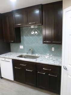 a kitchen with brown cabinets and white counter tops