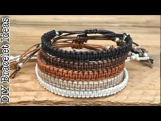 three different bracelets with white and brown beads on a wooden surface, one is made from