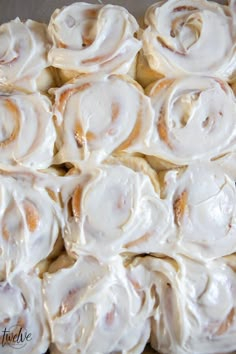 a close up view of cinnamon rolls with icing