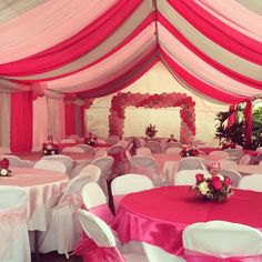 a banquet hall decorated with pink and white linens