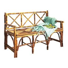 a bamboo bench with a blanket on it