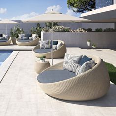 an outdoor seating area next to a swimming pool