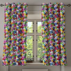 the window is decorated with multicolored flowers and has an open curtain to let in light