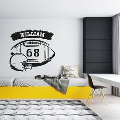 a bedroom with a football themed wall decal on the wall and a yellow bed