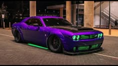 a purple sports car parked in front of a building with green lights on it's hood