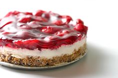 a cheesecake topped with cherries on a plate