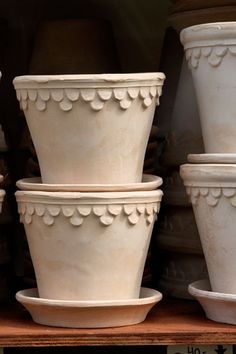 several white vases are stacked on top of each other