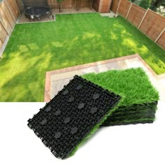 several pieces of black plastic sitting in the middle of a yard with grass growing on it