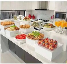 a kitchen counter filled with lots of different types of food and drinks on top of it