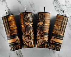 three harley davidson candles sitting on top of a marble counter