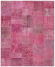 pink patchwork rug with various colors and patterns