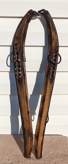 two wooden skis leaning against a white wall