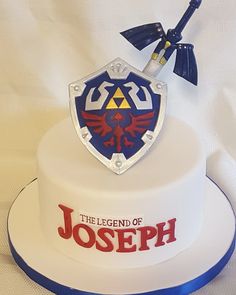 a white cake with a blue and red frosting on it that says the legend of joseph