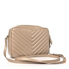 This is an authentic SAINT LAURENT Calfskin Matelasse Monogram Lou Camera Bag in Dark Beige. This chic shoulder bag is crafted of chevron-quilted calfskin leather in dark beige. This crossbody features an adjustable shoulder strap and aged gold hardware including a YSL logo on the front. The top zipper opens to a compact black fabric interior with a patch pocket. Denim Quilt, Ysl Logo, Bag Dark, Baguette Bag, Saint Laurent Bag, Dark Beige, Wallet Chain, Black Cross Body Bag, Black Fabric