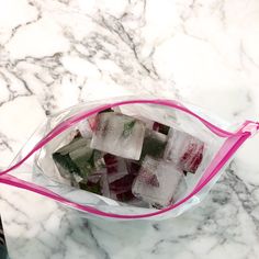 a bag filled with ice cubes sitting on top of a marble counter