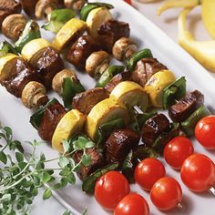 the skewers are prepared and ready to be served on the grill with cherry tomatoes