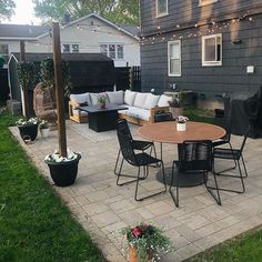 an outdoor patio with seating and string lights