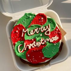 a decorated christmas cookie in a foam container